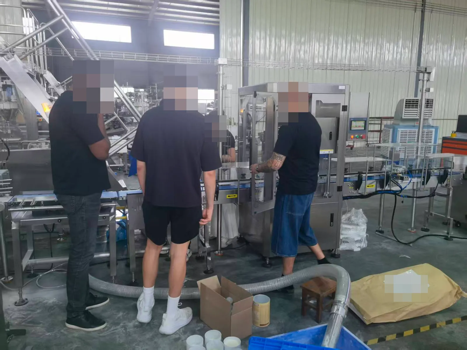 A production-line visit; people anonymised.