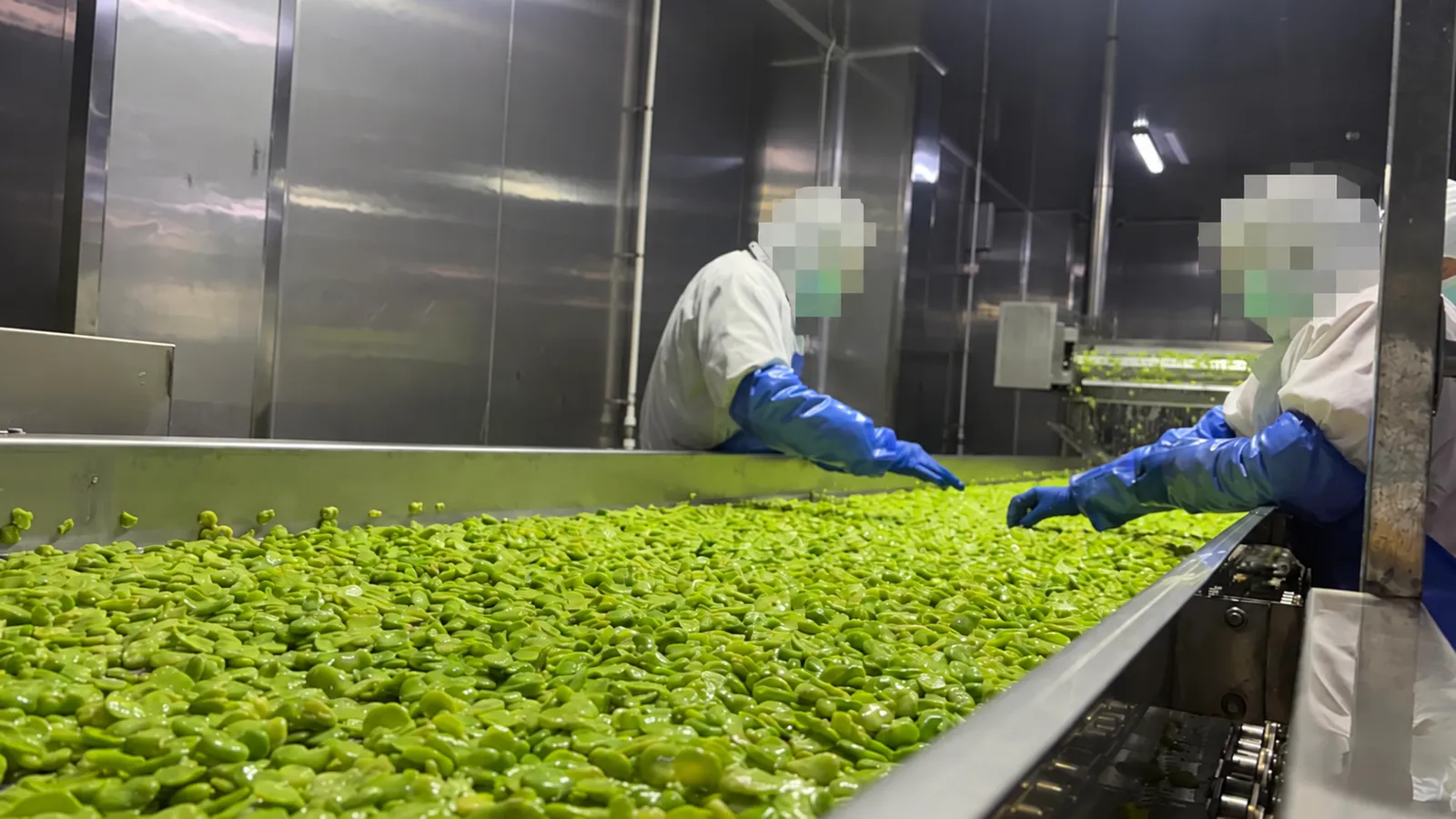Food processing on the production floor; people anonymised.